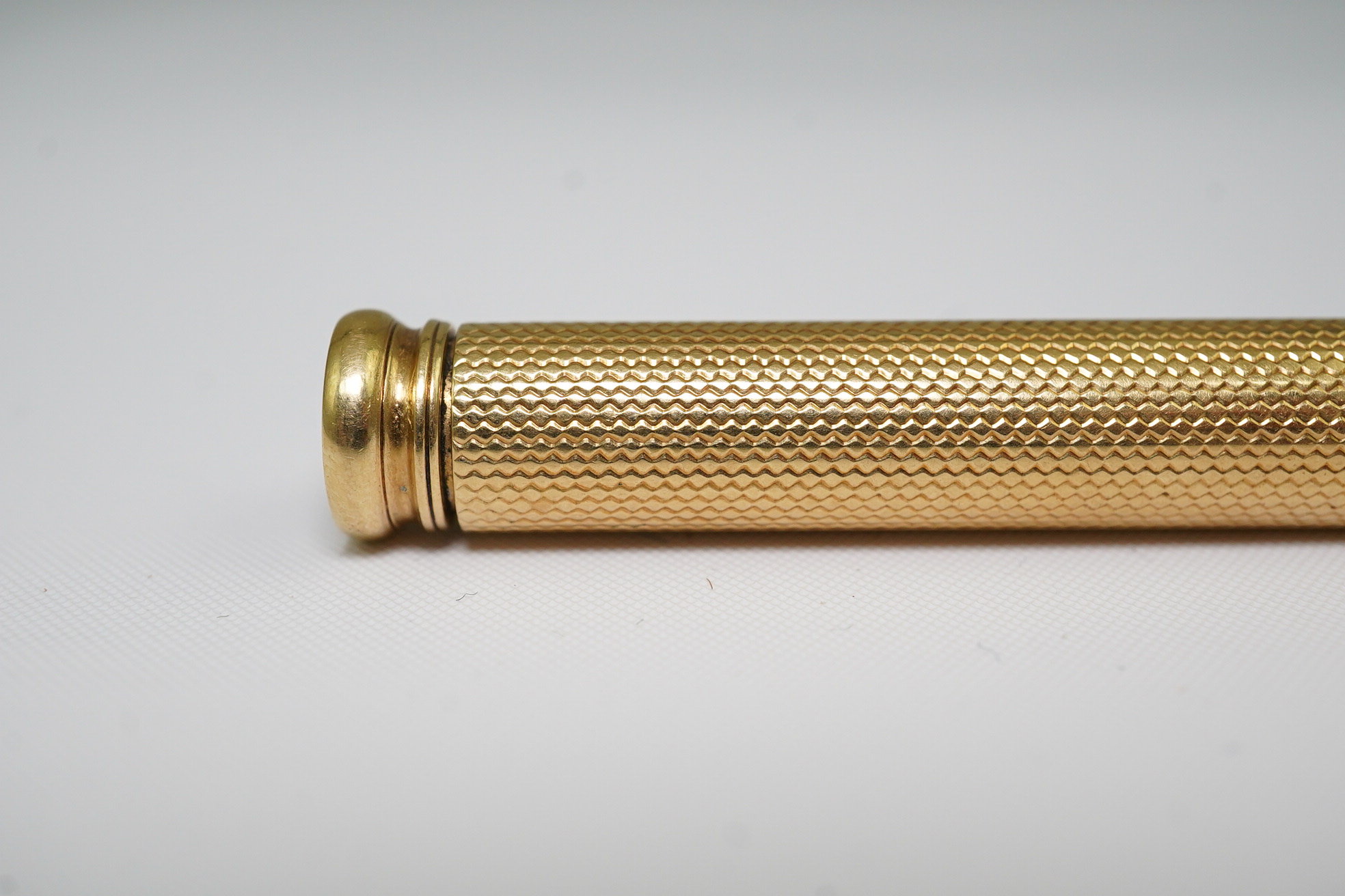 A late Victorian engine turned 18ct gold cased combination propelling pen and pencil, by Sampson Mordan & Co